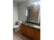 Bathroom with wooden vanity, single sink, and large mirror and shower at 831 N Fern Creek Ave # 101, Orlando, FL 32803