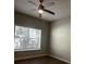 Well lit bedroom featuring a ceiling fan, wood-look floors, and a bright window at 831 N Fern Creek Ave # 101, Orlando, FL 32803