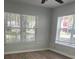 Bright bedroom with wood-look flooring and natural light coming through windows at 831 N Fern Creek Ave # 101, Orlando, FL 32803