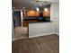 Efficient kitchen with wood cabinets and bar pass-through at 831 N Fern Creek Ave # 101, Orlando, FL 32803