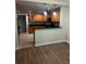 Stylish kitchen with wooden cabinets, black countertop, and modern appliances at 831 N Fern Creek Ave # 101, Orlando, FL 32803