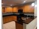 Spacious kitchen featuring wooden cabinets, dark countertops, and tile flooring at 831 N Fern Creek Ave # 101, Orlando, FL 32803