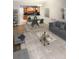 Open living room view towards kitchen with dining table, rug and gray sofa at 831 N Fern Creek Ave # 101, Orlando, FL 32803