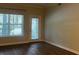 Bright living room featuring hardwood floors, natural light, and access to the outside at 831 N Fern Creek Ave # 101, Orlando, FL 32803