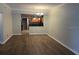 Open-concept living room featuring wood floors and a view into the kitchen at 831 N Fern Creek Ave # 101, Orlando, FL 32803
