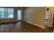 Open-concept living room with hardwood floors and natural light from a window and sliding glass door at 831 N Fern Creek Ave # 101, Orlando, FL 32803