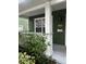 Inviting porch with white support columns and green facade of home at 831 N Fern Creek Ave # 101, Orlando, FL 32803