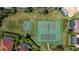 Aerial shot of community tennis and basketball courts surrounded by green space and residential homes at 8912 Heritage Bay Cir, Orlando, FL 32836