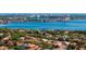 Scenic aerial view of a neighborhood near a lake, with diverse residential properties and the cityscape in the distance at 8912 Heritage Bay Cir, Orlando, FL 32836