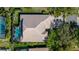 Aerial view showcasing the home's layout, screened pool, landscaped surroundings, and proximity to amenities at 8912 Heritage Bay Cir, Orlando, FL 32836