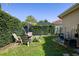 Private backyard offers a tranquil retreat with mature landscaping, a seating area, and a screened enclosure at 8912 Heritage Bay Cir, Orlando, FL 32836