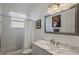Clean bathroom with shower over the tub, updated vanity, and decorative mirror at 8912 Heritage Bay Cir, Orlando, FL 32836