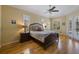 Serene bedroom featuring hardwood floors, natural light from multiple windows, and French doors at 8912 Heritage Bay Cir, Orlando, FL 32836