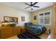 Cozy bedroom with a ceiling fan, shuttered window, and decorative accents, creating a relaxing and inviting space at 8912 Heritage Bay Cir, Orlando, FL 32836