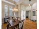 Elegant dining room featuring hardwood floors, large windows, and stylish chandelier lighting at 8912 Heritage Bay Cir, Orlando, FL 32836