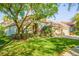 Beautiful single-story home with manicured lawn, garden, and mature shade tree at 8912 Heritage Bay Cir, Orlando, FL 32836
