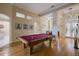 Bright game room featuring a hardwood floor and pool table with mauve cloth, surrounded by neutral walls and tasteful artwork at 8912 Heritage Bay Cir, Orlando, FL 32836