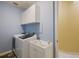 Well-organized laundry room featuring a washer, dryer, sink, and ample cabinet space for storage at 8912 Heritage Bay Cir, Orlando, FL 32836