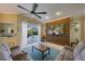 Bright living space with a decorative accent wall, sliding glass doors leading to a pool, and comfortable couches at 8912 Heritage Bay Cir, Orlando, FL 32836