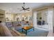 Inviting living room with an open floor plan, access to the patio, and an adjacent kitchen and dining area at 8912 Heritage Bay Cir, Orlando, FL 32836