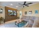 Cozy living room featuring a large TV wall, comfortable seating, and natural light at 8912 Heritage Bay Cir, Orlando, FL 32836