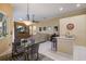 Comfortable living area with a decorative wall feature, large TV, neutral tones, and an adjacent breakfast nook at 8912 Heritage Bay Cir, Orlando, FL 32836