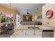 Open-concept living room with granite countertops, a breakfast nook, and a view of the backyard through large windows at 8912 Heritage Bay Cir, Orlando, FL 32836