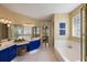 A well-lit main bathroom featuring double sinks, a separate shower, and a luxurious soaking tub at 8912 Heritage Bay Cir, Orlando, FL 32836