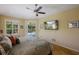 Comfortable main bedroom with a ceiling fan, television, and view to the pool through sliding glass doors at 8912 Heritage Bay Cir, Orlando, FL 32836