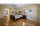Spacious main bedroom with hardwood floors, ceiling fan, ensuite bathroom access, and large windows at 8912 Heritage Bay Cir, Orlando, FL 32836