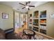 Home office with large, custom built-in bookshelves, wood floors, and a comfortable leather couch at 8912 Heritage Bay Cir, Orlando, FL 32836