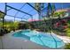 Beautiful pool and spa enclosed in screened lanai, surrounded by lush tropical landscaping for privacy at 8912 Heritage Bay Cir, Orlando, FL 32836