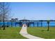 A serene waterfront scene with a charming gazebo and a distant view of a ferris wheel at 8912 Heritage Bay Cir, Orlando, FL 32836