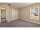 Bedroom with neutral walls, carpet flooring, closet doors and a large window for natural light at 935 Gloucester Court, Kissimmee, FL 34758