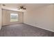 Spacious bedroom featuring neutral walls, carpet flooring, ceiling fan, and a window for natural light at 935 Gloucester Court, Kissimmee, FL 34758