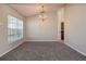 Cozy dining room with plush carpet and a chandelier at 935 Gloucester Court, Kissimmee, FL 34758