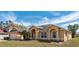 The exterior of the home showcasing a well-maintained lawn and neutral paint at 935 Gloucester Court, Kissimmee, FL 34758