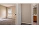 Hallway view into a bedroom with a window and a bathroom with a vanity and a door at 935 Gloucester Court, Kissimmee, FL 34758