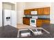 Modern kitchen with stainless steel sink, white appliances and plenty of counter space at 935 Gloucester Court, Kissimmee, FL 34758