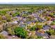 A community of beautiful homes with lush trees and green spaces from an aerial view at 10400 Hunters Trail Ct, Orlando, FL 32817