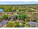 Aerial view of home with solar panels on its roof and lush mature landscaping surrounding the property at 10400 Hunters Trail Ct, Orlando, FL 32817