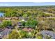 Aerial view of home with solar panels on its roof, lush trees surrounding the property and outlined in white at 10400 Hunters Trail Ct, Orlando, FL 32817