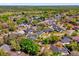 A sprawling residential area shows beautiful houses and lush greenery, captured from above at 10400 Hunters Trail Ct, Orlando, FL 32817