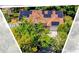 An aerial view of a house with solar panels is framed by an abstract border at 10400 Hunters Trail Ct, Orlando, FL 32817