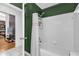 Well-lit bathroom with a shower and a view into a cozy living space at 10400 Hunters Trail Ct, Orlando, FL 32817