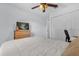 Bright bedroom features a bed, a television and a dresser with ample storage space at 10400 Hunters Trail Ct, Orlando, FL 32817