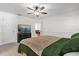 Bedroom with TV, carpet, ceiling fan, and neutral bedding at 10400 Hunters Trail Ct, Orlando, FL 32817