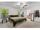 Bright bedroom features carpet, white walls, and large windows with lush greenery views at 10400 Hunters Trail Ct, Orlando, FL 32817