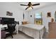 Cozy bedroom features a desk, a bed, and a view of the outdoors at 10400 Hunters Trail Ct, Orlando, FL 32817