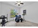 Bright bedroom with a large window, ceiling fan, and musical instruments; great natural light at 10400 Hunters Trail Ct, Orlando, FL 32817